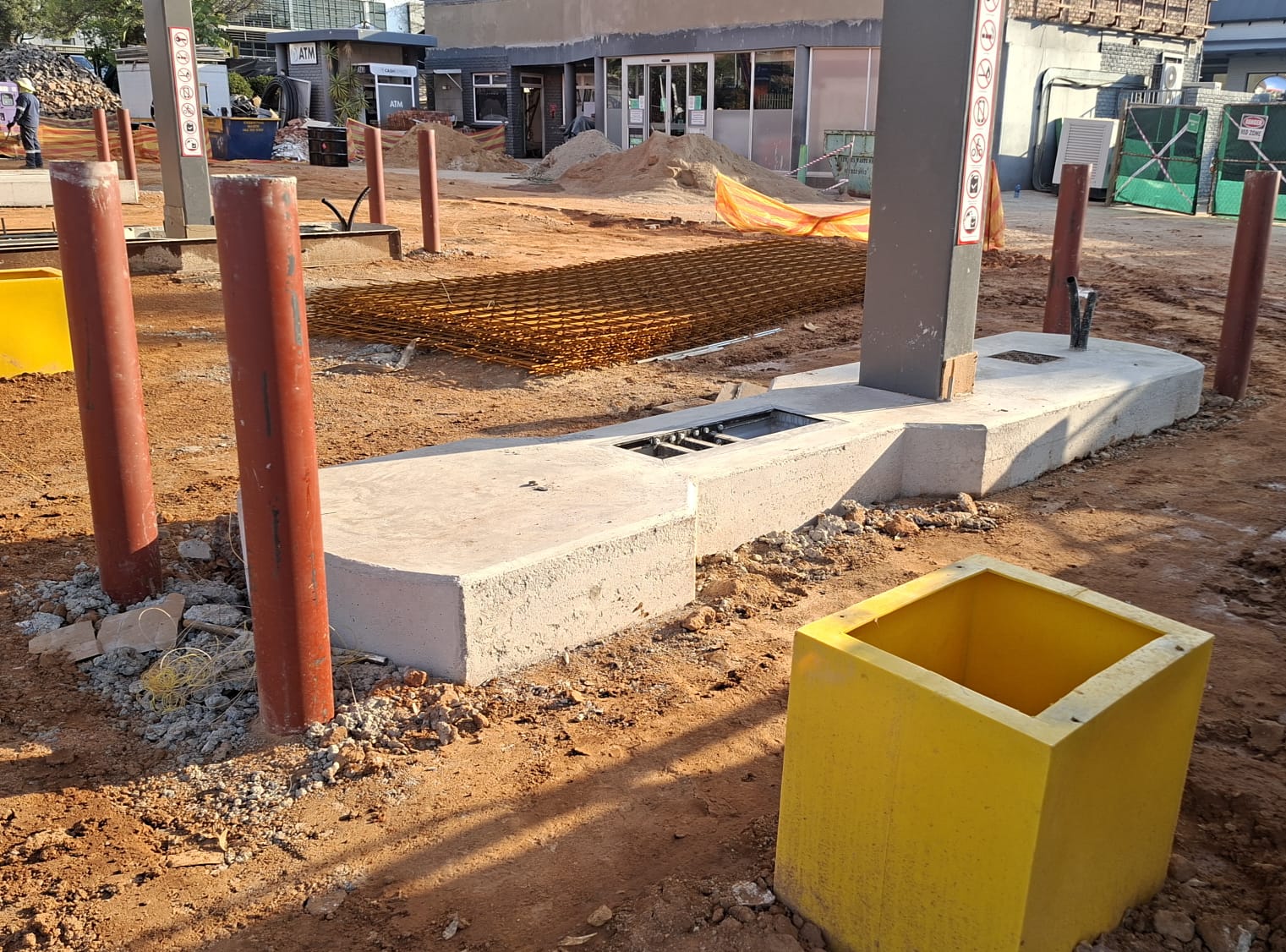 Concrete pump island, protective bollards and sump boxes during forecourt construction
